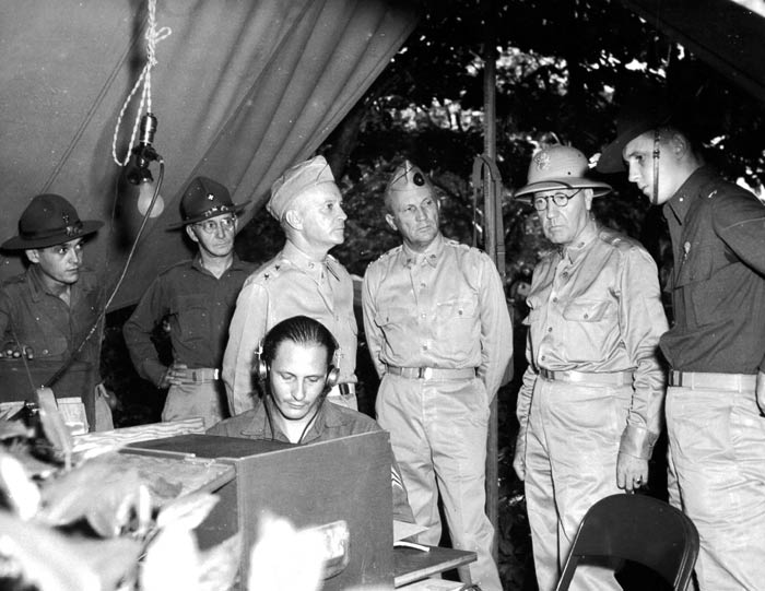 Lt. Gen. Andrews inspects the radio set at the C.P. of the Provisional Maneuver Force. LtoR: Capt. Riollano, Hq. Commandant, Lt. Col. Simmons, Chief of Staff of the Prov. Man. Force, Maj. Gen Collins, Lt. Gen. Andrews, Brig. Gen. Ingles and 1st Lt. Blair, Signal Officer of the P.M. Force. Puerto Rico. November 1941.  SC 126175